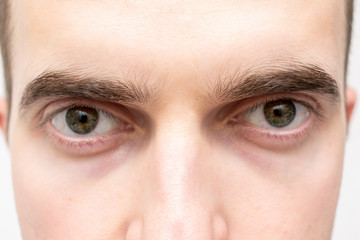 Face of serious man, man's eyes, cropped image, closeup