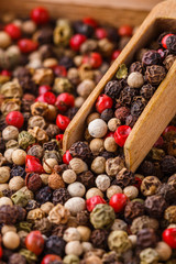 mix of peppercorns on white acrylic background