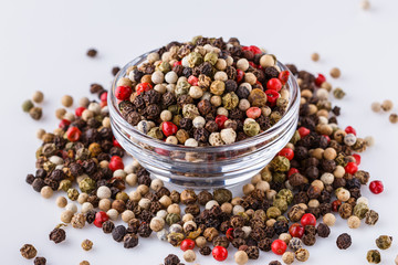 mix of peppercorns on white acrylic background