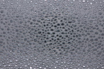 silver drops on metal surface