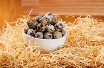 quail eggs on top of a straw background