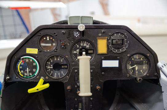Instrument panel inside the cockpit of a glider inside the hangar. Light airplane control deck
