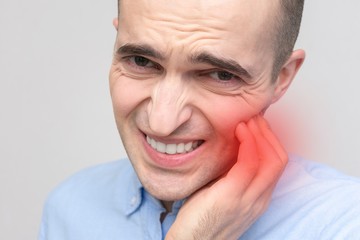 Concept of toothache. Man's teeth hurt, portrait, closeup