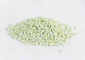 Pile of green chemical fertilizer isolated on white. Gardening time.