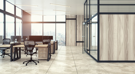 The modern open space office interior with wooden walls and panoramic windows with cityscape and rows of gray and wooden computer desks. 3d rendering