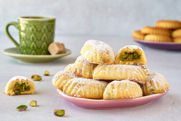 Arab sweets. Traditional eid semolina  maamoul or mamoul  cookies with dates and pistachio nuts