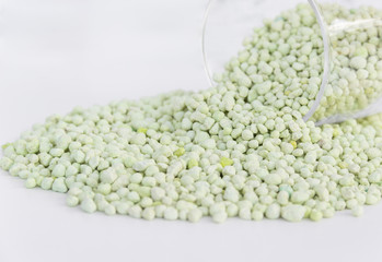 Pile of green chemical fertilizer isolated on white. Gardening time.