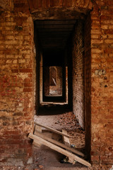 Fototapeta na wymiar Crumbling brick in an old abandoned building