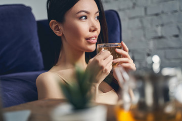 Beautiful young lady holding cup of tea
