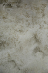 
Dirty yellow water with foam on a water-dam. Splashing rusty water