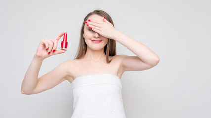 Happy woman shows red nail polish, portrait, white background, copy space, 16:9