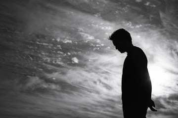 Silhouette of man with face down feeling sad  © kieferpix