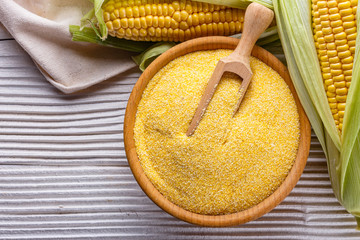 Polenta corn porridge on white wooden rustic background