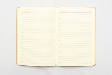 Open notebook on white background, top view, copy space