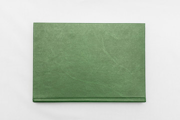Green book, white background, top view