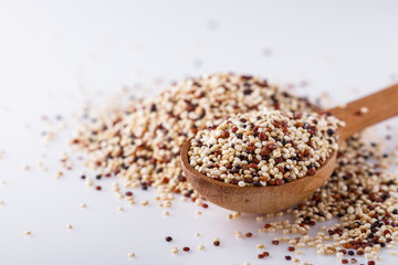 mix of quinoa grains on white acrylic background