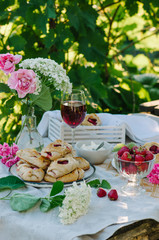 Sweet buns on a table with strawberries. Rustic style photo in nature.