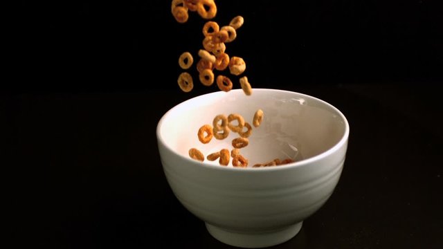 Circular cereal being poured into a bowl