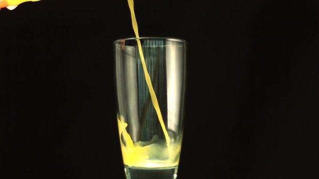 Orange juice filling a glass