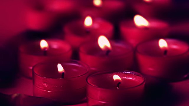 Pink candles flickering in a breeze
