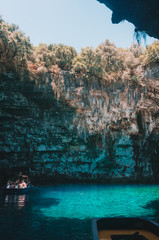 Boat floats inside Melissani Cave. Kefalonia island, Greece