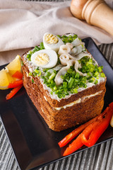 a huge herring sandwich with mayonnaise and quail eggs