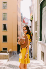 Obraz premium fashion woman wearing summer dress and sunglasses walk in street outdoors