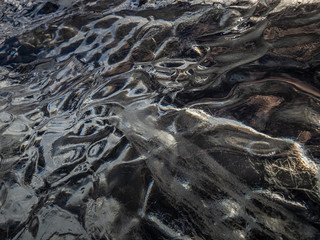 Ice structures on the black lava beach, placed near Jokulsarlon glacier lagoon.