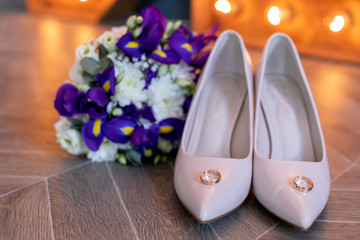 wedding rings, wedding shoes and a bouquet