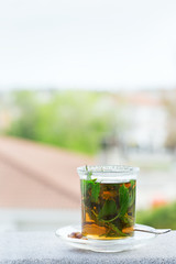 Glass of hot mint tea, traditional moroccan moorish beverage