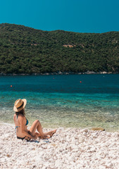 Fototapeta na wymiar Woman relaxing on the beach. Kefalonia Island, Greece