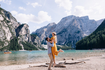 couple walk and have fun along the Lago di Braies in Italy.