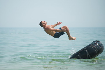Man jumps from an inflated camera into the sea