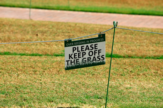 "Please Keep Off The Grass" sign