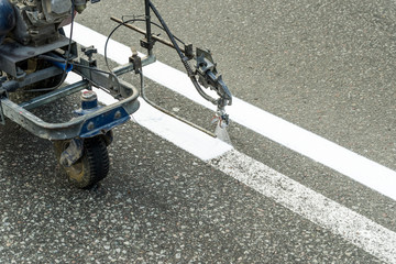 Automated painting by airbrushing of a road using spraying for driving direction, road repair...