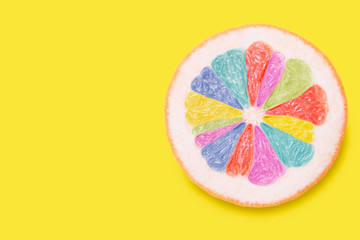 Colored sliced ​​grapefruit isolated on yellow with copy space. Creative summer concept © Alina