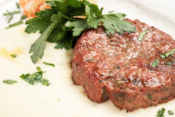 mashed potatoes with beef and pork cutlet on a white plat