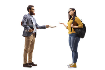 Fototapeta premium Bearded male teacher giving a book to a female student