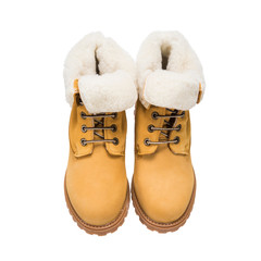 light brown winter boots with fur in everyday wear in cold weather, isolated clothing accessories on a white background