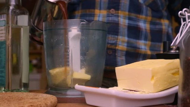 Person making bulletproof coffee with butter and MCT oil