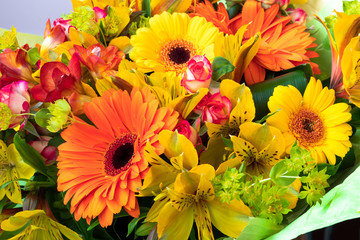 Bright yellow and orange gerbera in a bouquet of flowers. Beautiful bouquet gift for the holiday. Flowering plants as a postcard.