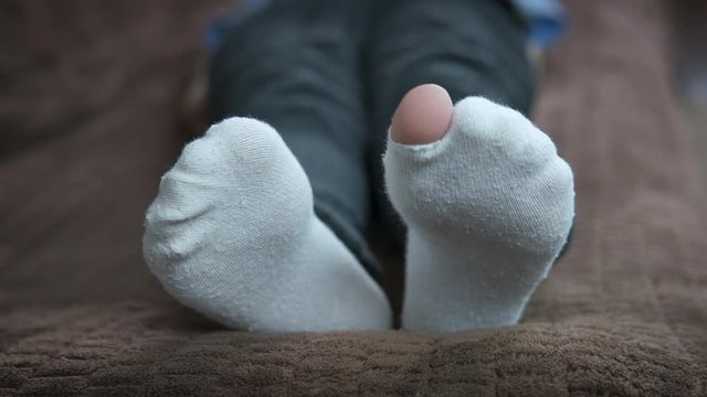 Torn sock. Childhood is in poverty.