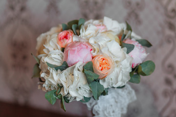 wedding bouquet of white roses and peach peonies close-up