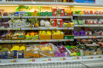 fruits and vegetables in packages on the shelves of the supermarket