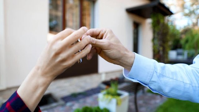housing business - real estate agent giving new house keys to client
