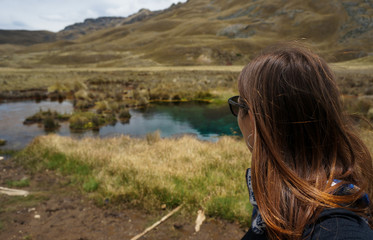 Girl watches a lake in Huascaran Park, Peru