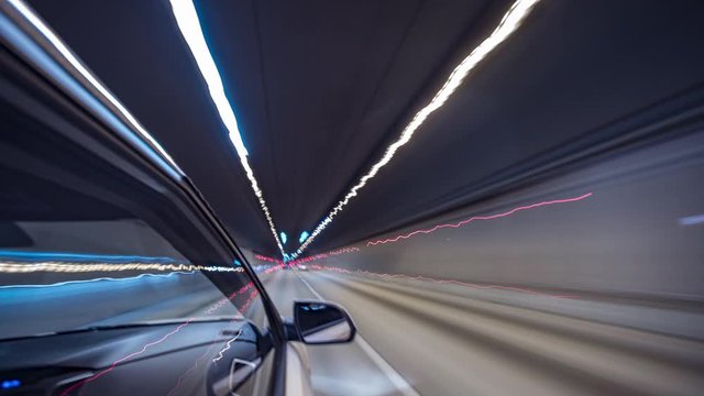 Timelapse video View from Side of Car moving in a night city, Blured road with lights with car on high speed. Concept rapid rhythm of a modern city.