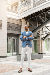 beautiful young african stands near the building