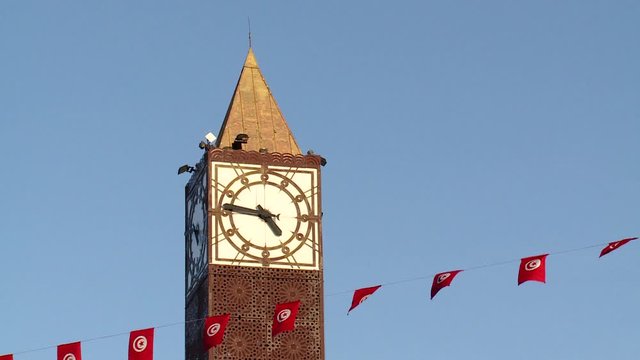 Tower clock with flags in Tunis, Tunisia