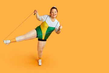 Fototapeta na wymiar Doing sports with a skipping rope in hand. Sports Equipment. The desire to lose weight.
